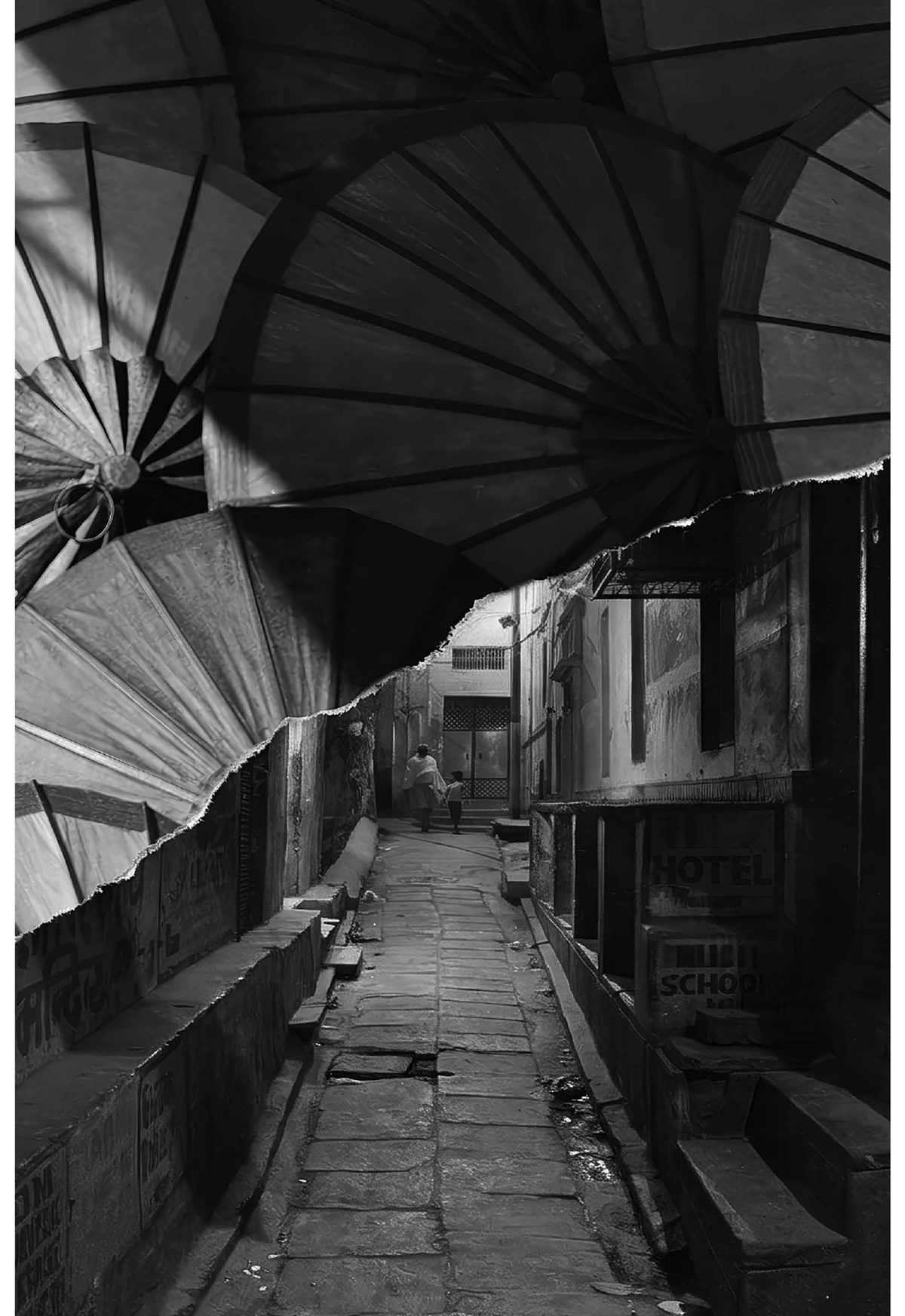 A narrow Varanasi lane seen through paper parasols — photograph by Cesca